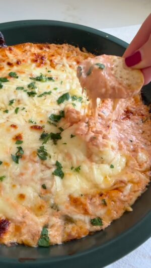Dina Deleasa Instagram - Crab Fra Diavolo Dip is what you need for Christmas Eve and beyond. If you are Italian American you may be planning your Seven Fishes menu. Maybe you are like my family where you have one too many favorites. This is a great way to serve an old favorite in a new way! Keep in mind if you like things on the spicier side adjust the red pepper and hot sauce according to your tolerance!

Buon Natale! Recipe below, share it like it, love it! Can’t wait to share more recipes and traditions over the next couple of days. Make sure to follow along with @dishitgirldina. And if you need a great recipe for Zuppa Di Clams, head over to dishitgirl.com!

1 tbsp olive oil
3 large garlic cloves, finely chopped
3 tbsp finely chopped yellow onion
1 tsp red pepper flakes
1 cup crab claw meat
3 tbsp white wine
1 tbsp lemon juice
1 tbsp unsalted butter
1/2 cup crushed tomatoes
1 tsp kosher salt
1/2 tsp black pepper
 8oz cream cheese
1/4 cup mascarpone cheese
1/4 cup mayo
2 tsp hot sauce
I cup shredded mozzarella cheese, divided
1/4 cup shredded parmesan cheese
fresh parsley for garnish

Preheat the oven to 350 degrees.
Heat olive oil in a large saute pan over medium heat, add the garlic and onion, saute for 3 minutes until onions become translucent. Then add the crab, breaking it up with a wooden spoon as you saute another 2 minutes, Then pour in the wine and lemon juice,  let it simmer for another 4 minutes, then add the crushed tomatoes, season with salt and pepper, stir to incorporate. Let it saute gently for another 3 minutes, turn off the heat.

In a large bowl add the cream cheese, mascarpone, mayo, and hot sauce. Using an electric mixer on a medium speed mix together until uniform and smooth. Fold in 1/2 cup of the mozzarella cheese. Then add the crab mixture and fold in gently until well combined. Pour the mixture into a 9 inch pie dish. Top with the rest of the mozzarella cheese, along with the parmesan. Place in the preheated oven for about 20 minutes until the top becomes bubbly and brown.