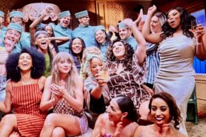Eliotte Woodford Instagram - Making #TheFateofOphelia MV was not only a nostalgic family reunion but also an exciting celebration of the masterful musical future @taylorswift was creating in real time right before our eyes. 🤩
My heart was overflowing with JOY just getting to be back with my friends that are family and on top of that, we got to put on the COOLEST SKIT EVER! 😂 🎭🎬
My musical theater loving soul couldn’t handle the scale and beauty of each set, wig, costume, and choreography. I was overcome with emotion and gratitude more than once during this shoot. The large scale MGM movie musicals and dream ballets I had always dreamt of being a part of were happening and I now got to be included. 🥹😭🥹
Bravo to the incredible crew that made this happen and to @nopenother and @amandabalen for ALWAYS creating and leading with such grace and genius. 👏🏾👏🏾👏🏾
I just can’t believe I get to be a part of the magical worlds @taylorswift consistently creates. Thank you for including me, and all of us, on this ride, T!
Also- I can’t believe we were in MOVIE THEATERS AGAIN! 🤯
I will always be proud to live #TheLifeofaShowgirl
😘❤️🔥💃🏽