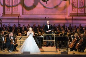 Megan Hilty Instagram - What are you doing 12/19 & 12/20? Wanna join me at Carnegie Hall and get in the Holiday spirit?! I’ll be singing with all of my favorite people: 
✅the incomparable Maestro @stevenreineke 
✅world renowned @thenewyorkpops 
✅and the acclaimed Essential Voices USA Choir!

This pic was taken 8 years ago by @richardtermine and captures one of the most thrilling experiences I’ve ever had onstage!  I can’t wait to sing with all of them again and spread some Holiday cheer!  I hope you’ll join us! Link for tix in bio! ☃️ 🎄 💋