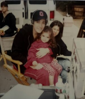 Melina Kanakaredes Instagram - Thomas Wolf said: “You can never go home again” but John Masius believed that with a little divine “PROVIDENCE” #SydHansen could!♥️ 26 years ago this show changed so many lives - especially mine!! I LOVED playing Syd Hansen! From the DREAMS and  COSTUMES to the amazing FAMILY we became in front of and especially behind the camera— Thank you John for creating #Providence♥️ And thank you to @scarletmasius for giving me that polaroid of us when we first met on the set!! I hope you all enjoy these photos as much as I did. ♥️ RIP John♥️