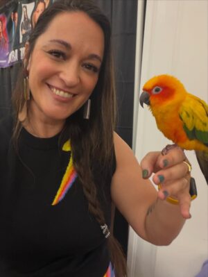 Sara Tomko Instagram - Albuquerque, you floored me with so many gifts today of affirmation, art, joy, abundance, Mango the flirty parrot and even Asta’s namesake, Asta Blu! Who survived the NICU🥹 and is already so strong.  I am so honored to be forever linked to you, sweet baby.  Thank you for a great con @abqcomcon You make me blush with love 🍭💫🌅🙏🏽✨
•••
Fit by @oxknitclothing 🌞🙏🏽