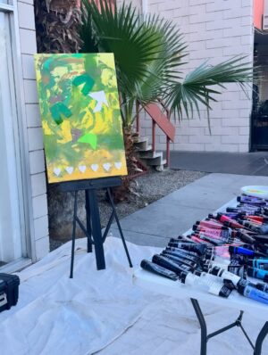 Dawn McCoy Instagram - This collaborative painting was made during @desertopenstudios at @janssenartspace 

During three days six of us created this piece. We were all so different that I wondered how it would turn out. Look through all the pictures to see the transformation. It started out green and yellow. Then a black and white spritz. I added hearts and @tjanderson.studio added blocks of wood and acrylic. Just when it looked hopeless I added a wash of light pink. Then @arron_buttram_art came to the rescue and added structure and ideas. 

This painting will be on display this Friday at the opening 5-8pm. All proceeds will be donated to the @lovingwayfoundation that was founded by @iamdawnmccoy 🩵🩷

Other artists that participated in creating this piece were @studioroth.ps @tjanderson.studio and @mid_mod_facade 

If you’re in town, be sure to see the painting in person!

#pinkart #artheals #lovingwayfoundation #artdonation #collaboration