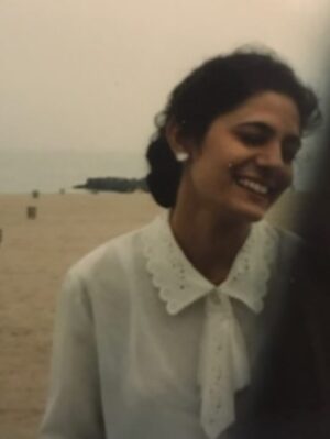 Raveena Aurora Instagram - it’s hard to process that this will be my last year with you that you were alive . in one way, I couldn’t be more ready to leap out of the devastation and chaos of this year and into the shiny hope of 2026. and in another way, i keep looking thru the photo roll of this year… thinking how the 7 months i had left with  you were barely enough. there aren’t nearly enough photos, voice notes, videos of you  to satisfy - i want to claw myself back thru time to January and do everything differently. The grief and depression never seems to lift, but instead, stretches over time into different shapes .. its coloring my dancing, singing voice, & writing in new shades of wisdom and sadness. the only reprieve  is to make more art . 

I’m bargaining now with the quickness of years passing by, and soon - decades . 
I want the freshness of these 2025 memories at the forefront of all our minds. I can’t afford to have anyone forget you . I don’t want you to become some faded photograph to my kids. Some relic of the past, their mouth ajar that someone could really be born in 1968. Laughing at the concept of “ancient” , “old people stuff” “old fashioned”. Maybe romanticizing it years later. 

I’ll think - Every moment in the past was a whole world, filled with all of the noise of that present moment. I look at “ancient” differently now. One day you and I - we’ll be ancient. 

They will not know Bollywood tapes in the car in 2004, sticky jalebi stuck between  two thin sheets of white oiled up paper, of car-ride boredom, or your hair in a neatly fashioned bun above a camel Banana republic blazer, your accent that sweetened alll words.
I will tell them you were the most beautiful girl in 1994, that your laughter was a room I’d like to enter again, that you knew all the practical things like how to use a sewing machine or thread an upper lip. It won’t mean much to them, until it’s too late. Until I’m slipping way and myself, ancient - and they too, will be pressing a tape recorder up against my lips, trying to preserve every last memory of me before it’s too late. life is a spiral , a loop, a cosmic trick . blink and it will be too late. nothing is ours to hold, not even our mothers