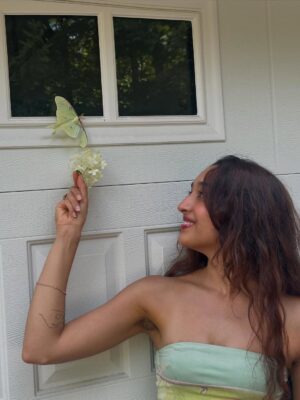 Raveena Aurora Instagram - MAMA CAME BACK TO GIVE US A SIGN😭🦋🦋 after I was searching for the rare luna moth to see in person for the last 3 years - she appeared resting on our garage door for hours -  the same day we brought moms ashes home. All the magical coincidences of me also wearing a Luna moth dress on this day, of Pluto (the song about coming back after death as a butterfly) being her favorite song and the last song of mine she asked me to sing to her before she passed, of the same butterfly being sprawled all over the album covers and merch and now tattooed on my body, and the fact that it’s  so rare to see the Luna moth in person because of its nocturnal nature … it’s all too perfect and magical 🩵 Im starting to feel my angel all around me , even thru the endless tears 😭😭😭😭😭😭