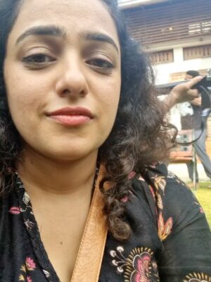 Nithya Menen Instagram - Some behind the scenes stuff I had from the shoot. Miss the crazy group - the girls all crammed into one room , which also doubled as the costume room . The boys so afraid to enter that room always :D ‘My’ spot on the couch - which no one sat on ever 🤍:) The early early mornings - driving to location with @sayanoraphilip on most days before the sunrise…. Music on sets always.  But most importantly ,no make up no assistants.. Just a happy bunch , having a lot of fun together.
@wonderwomenfilm @anjalimenonfilms @simply.nadiya @par_vathy @padmapriya_off @sayanoraphilip @archana_padmini @amrutasubhash @_its_me_caroline